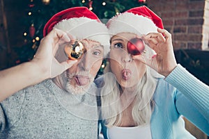 Close-up portrait of two playful charming nice grey-haired peopl