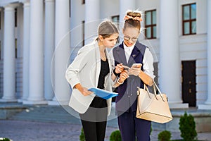 Close-up portrait of two young business girls