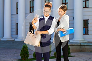 Close-up portrait of two young business girls