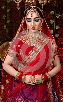 Close up Portrait of very beautiful indian Bride in bridal costume with makeup and stone jewellery