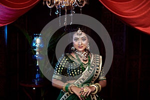 Close up Portrait of very beautiful indian Bride in bridal costume with makeup and stone jewellery