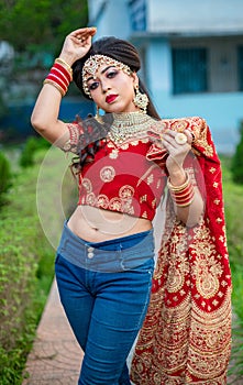 Close up Portrait of very beautiful sexy indian bride in red lehenga showing navel. Non Bengali bridal portrait