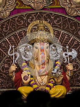 Close up , portrait view of decorated and garlanded Isolated idol of Hindu God Ganesha in Pune ,Maharashtra, India.