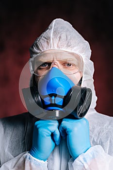 Close-up portrait of virologist medical worker wearing protective suit.