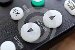 A close up portrait of the volume up and down buttons on a radio, television or surround sound system, used to alter the sound