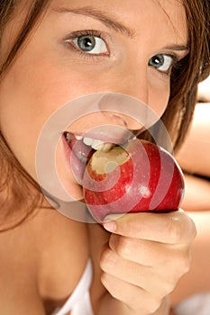 Close-up portrait of woman with apple