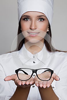 Close up portrait of woman doctor oculist giving glasses
