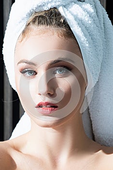 Close up portrait of woman posing wrapped in bathroom towels, Beauty portrait of a cheerful attractive half naked woman