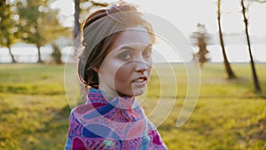 Close Up Portrait of Woman Standing in autumn park and looking tothe camera.