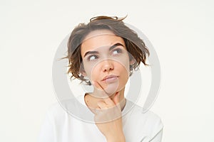 Close up portrait of woman with thoughtful face, thinking of solution, pondering, making choice, standing over white