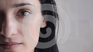 Close-up Portrait of Young Adult Brunette Woman. Half Face. Beautiful Girl Open Her Eyes and looking at camera