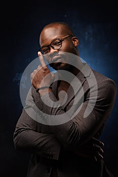 Close up portrait of young african man isolated on black studio background