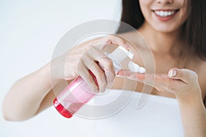 Close up portrait of young asian woman with cosmetic foam for washing in hands on white background