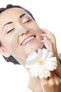 Young asian woman holding white gerber flower