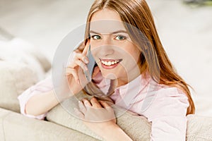 Close up portrait of young attractive girl talking on cell phone.