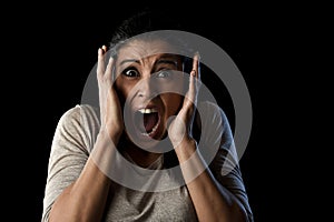 Close up portrait young attractive Latin woman screaming desperate screaming in primal fear emotion