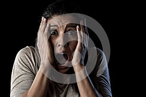 Close up portrait young attractive Latin woman screaming desperate screaming in primal fear emotion