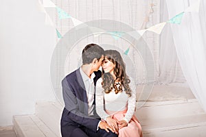 Close up portrait of young attractive romantic couple hugging and kissing. Love and relationships lifestyle, interior