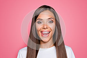 Close up portrait of young attractive woman with long brunette hair seductively licking her lips and look at the camera