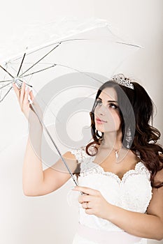 Close-up portrait of young beautiful bride in a wedding dress with a wedding makeup and hairstyle. girl holding white