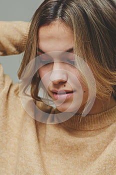 Close up portrait of a young beautiful caucasian woman with many moles or birthmarks on her face. Toned image