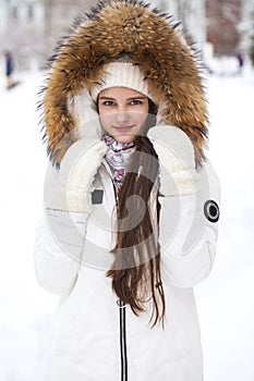 Close up portrait of a young beautiful girl with a fur hood