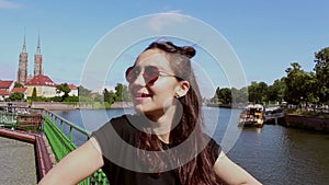 Close up portrait of a young beautiful girl in sunglasses.The girl looks at the camera and smiles.