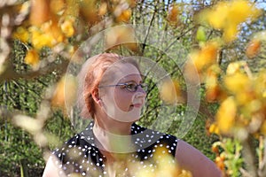 Close up portrait, Young beautiful red haired woman posing outdoors in sunny weather