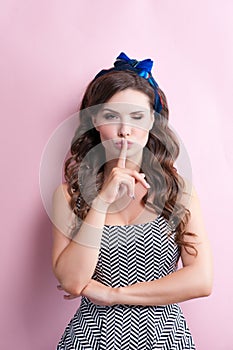 Close-up portrait of young beautiful slim young woman in a retro pin-up style in dress with red sensual lips