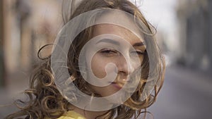 Close up portrait of Young Brunette Woman with cute freckles at sunset, Girl wearing blue jeans jacket, sunbeams in hair