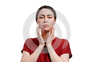 Close-up portrait of a young caucasian beautiful woman touching her skin with her hands. White background. Copy space. The concept