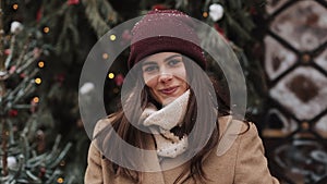 Close Up Portrait of Young Charming Brunnete Girl Wearing in Hat and Mittens Waving Looking to Camera and Smiling