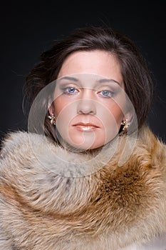 Close up portrait of young fashion woman in fur