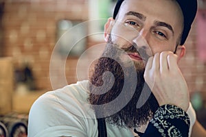 Close-up portrait of a young and fashionable male hairstylist