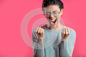 Close up portrait of young female squealing with delight