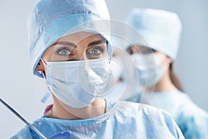 Close-up portrait of young female surgeon doctor