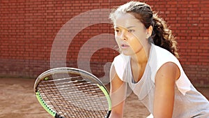 Close up portrait of young female tennis player concentrating on her game