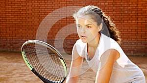 Close up portrait of young female tennis player concentrating on her game