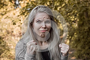 Close up portrait of a young girl with an angry face expression who desperately battles the offender