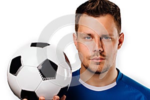 Close-up portrait of young handsome football player soccer posing on white isolated.