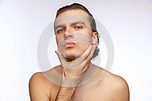 Close-up portrait of young handsome man isolated on white studio background. Concept of men& x27;s health, beauty, self