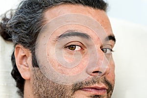 Close up portrait of young handsome man looking into the camera