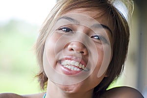 Close up portrait of young happy and beautiful expressive Asian woman smiling excited and nice in positive face expression