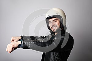Close-up portrait of young happy biker man with white cafe-racer helmet. Colourful background.