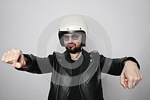 Close-up portrait of young happy biker man with white cafe-racer helmet. White background.