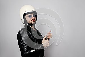 Close-up portrait of young happy biker man with white cafe-racer helmet. White background.