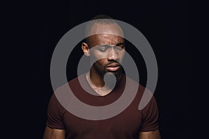 Close up portrait of young man isolated on black studio background