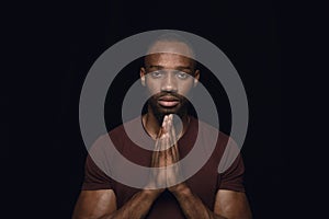 Close up portrait of young man isolated on black studio background