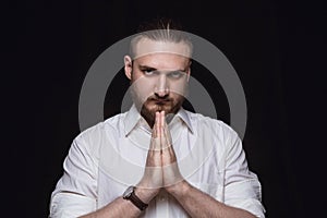 Close up portrait of young man isolated on black studio background