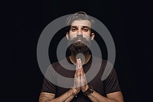 Close up portrait of young man isolated on black studio background